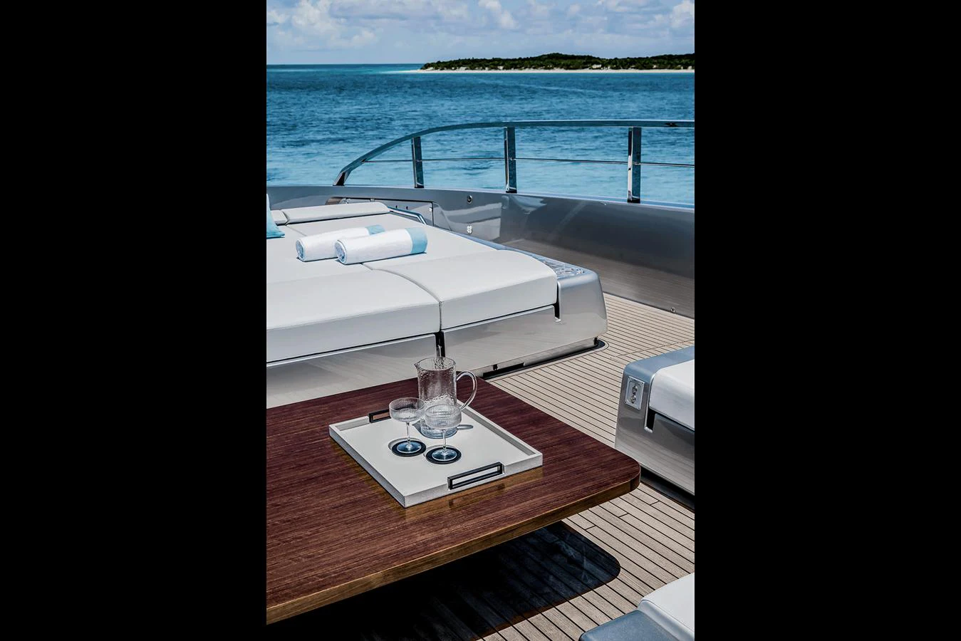 The sundeck offers a luxurious space with sun loungers and a scenic ocean view. aboard RIVA 130/02 Yacht for Sale