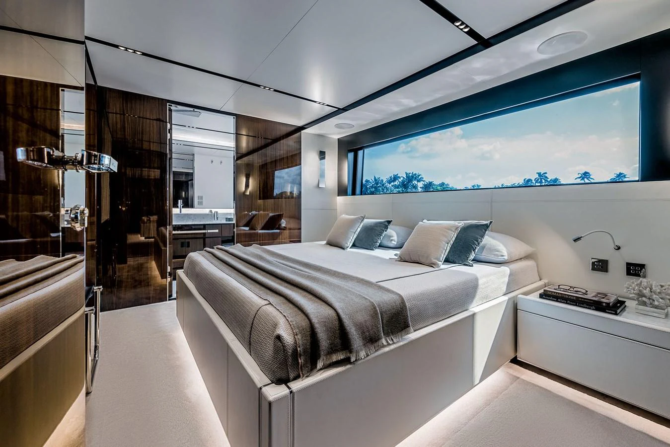 The master stateroom features a luxurious bed with elegant bedding and a large window offering a scenic view. aboard RIVA 130/02 Yacht for Sale