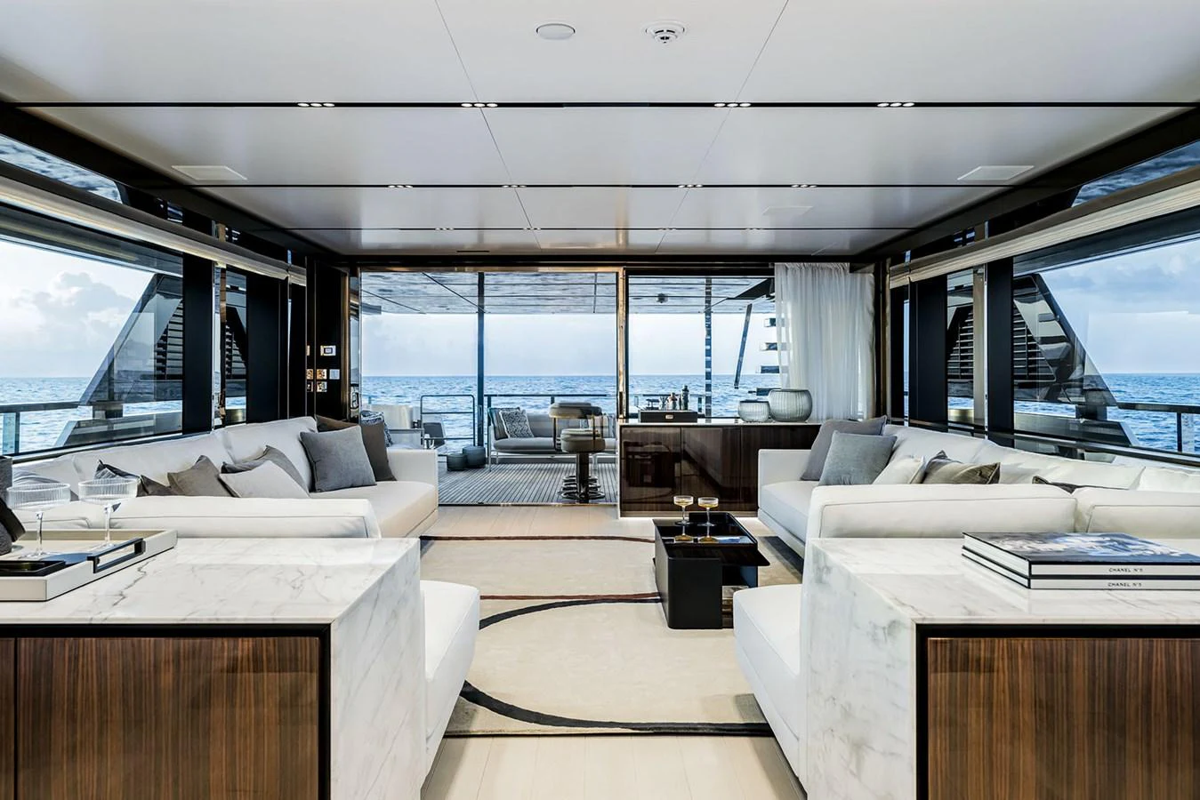 The salon offers a luxurious and spacious area with elegant furnishings and panoramic ocean views. aboard RIVA 130/02 Yacht for Sale