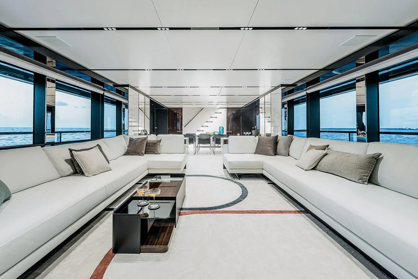 The spacious salon features luxurious seating with panoramic ocean views. aboard RIVA 130/02 Yacht for Sale