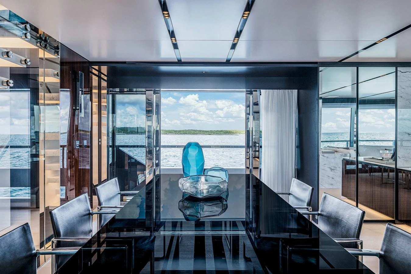 The yacht's dining area features a sleek, modern design with a stunning view of the sea. aboard RIVA 130/02 Yacht for Sale