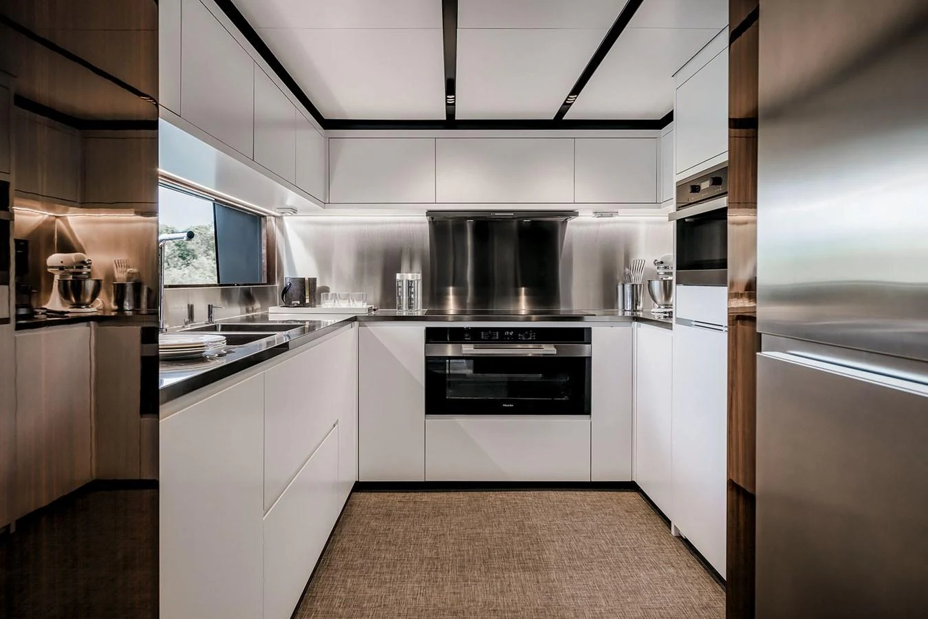 The yacht's galley features modern appliances and sleek cabinetry, creating a sophisticated culinary space. aboard RIVA 130/02 Yacht for Sale