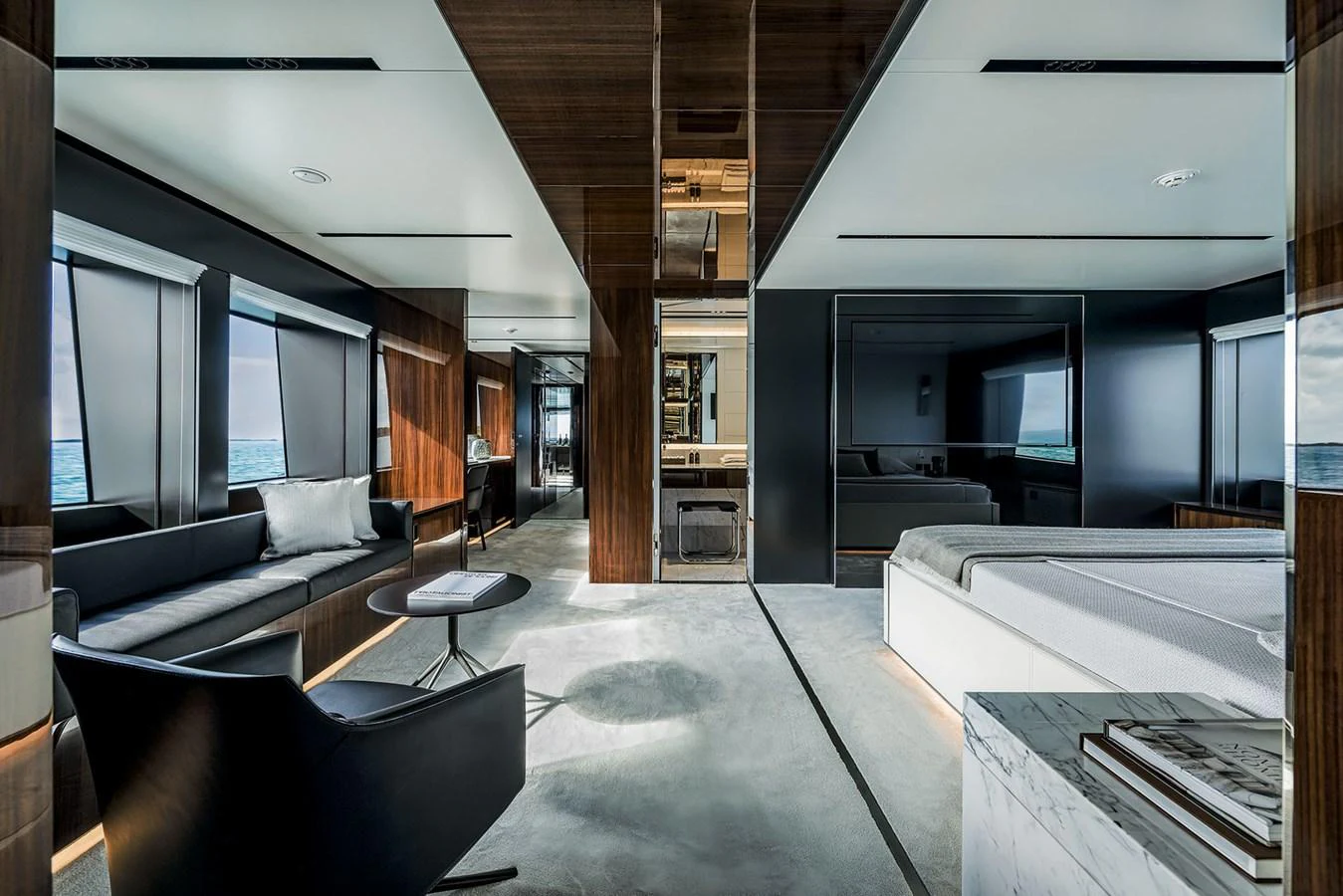 The master stateroom features modern furnishings and expansive windows with ocean views. aboard RIVA 130/02 Yacht for Sale
