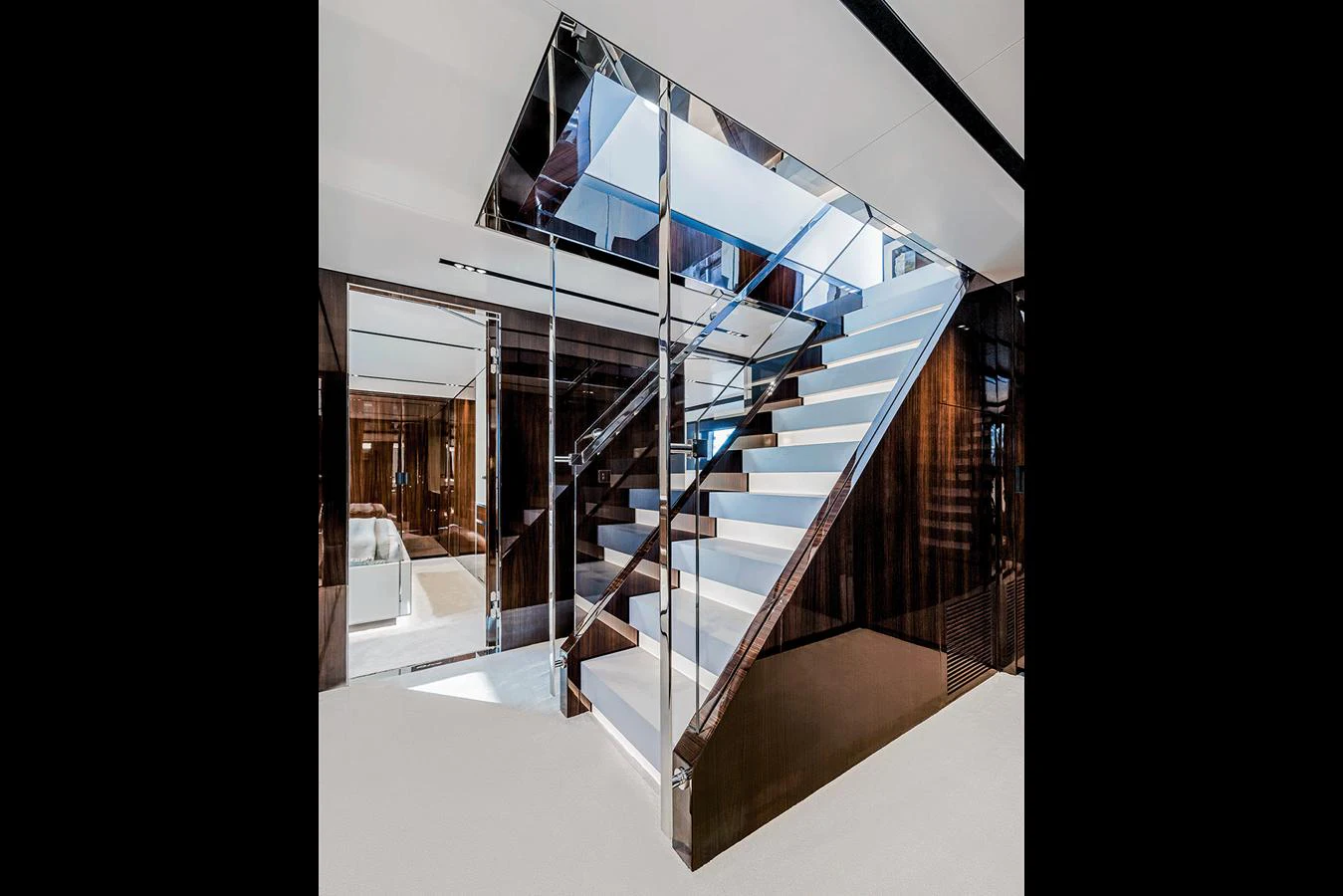 A sleek and modern staircase with glass railings and polished finishes. aboard RIVA 130/02 Yacht for Sale