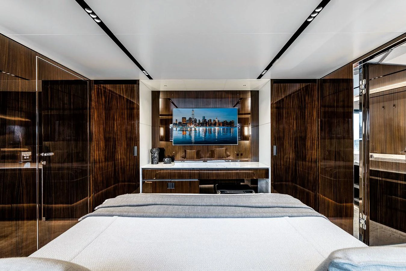 The master stateroom features elegant wood paneling and a large flat-screen TV. aboard RIVA 130/02 Yacht for Sale
