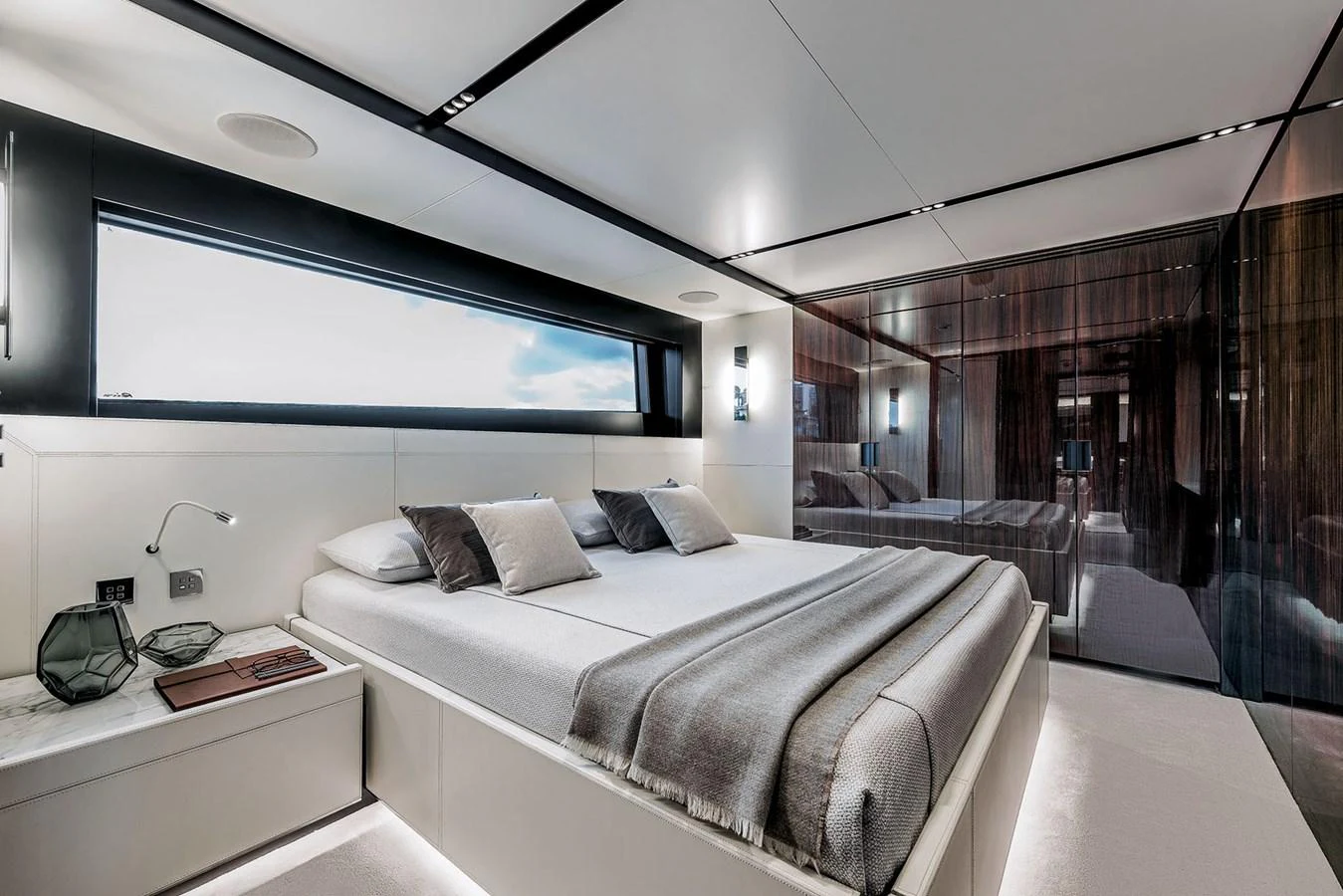 The master stateroom features a luxurious bed with modern decor and ample natural light. aboard RIVA 130/02 Yacht for Sale