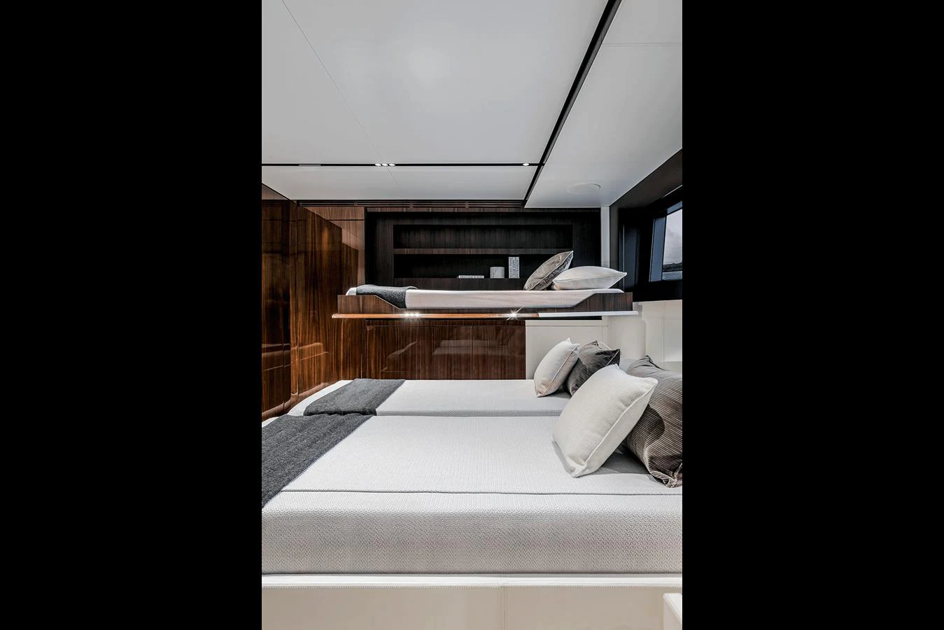 The guest stateroom features modern design with comfortable bedding and sleek wood finishes. aboard RIVA 130/02 Yacht for Sale