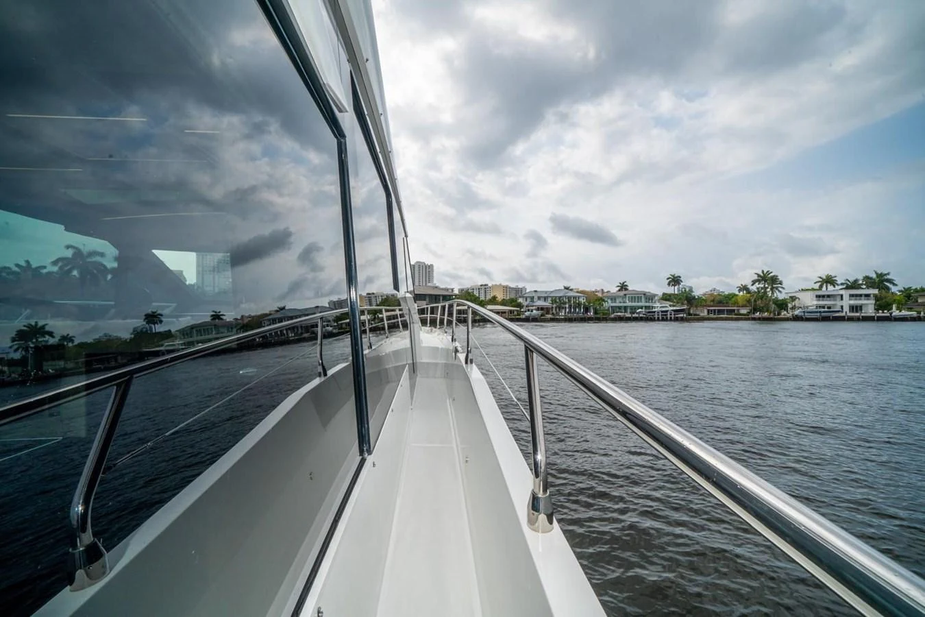 The yacht's sleek exterior is showcased as it cruises along a scenic waterfront. aboard GALEON Yacht for Sale