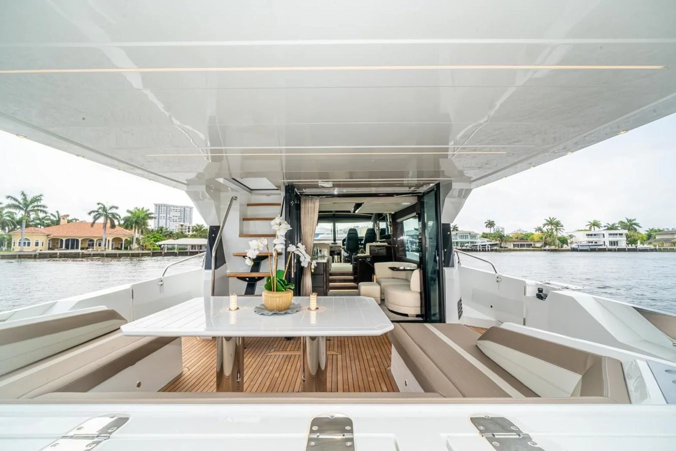 The aft deck features a spacious dining area with a view of the water and luxurious seating. aboard GALEON Yacht for Sale