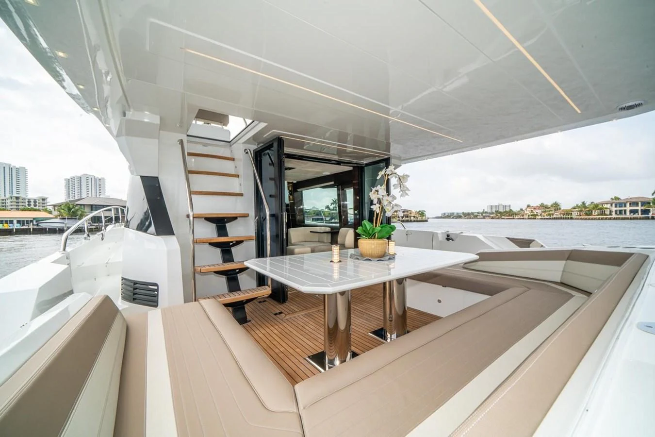 The aft deck features a spacious seating area with a table, perfect for alfresco dining and relaxation. aboard GALEON Yacht for Sale