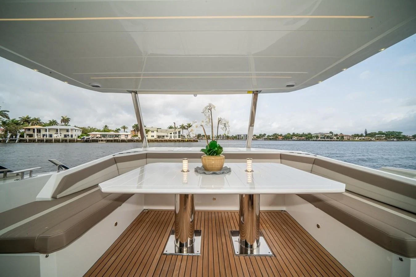 The aft deck features a stylish dining area with a sleek table and comfortable seating, perfect for enjoying meals with a view. aboard GALEON Yacht for Sale