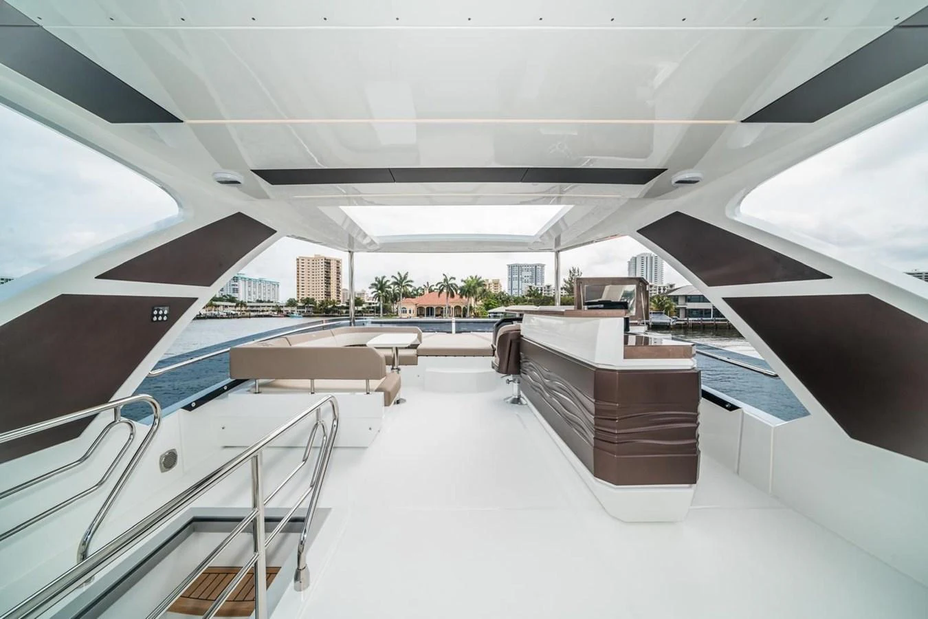 The flybridge offers a spacious and modern area with ample seating and a sleek bar setup, perfect for entertaining while enjoying panoramic views. aboard GALEON Yacht for Sale