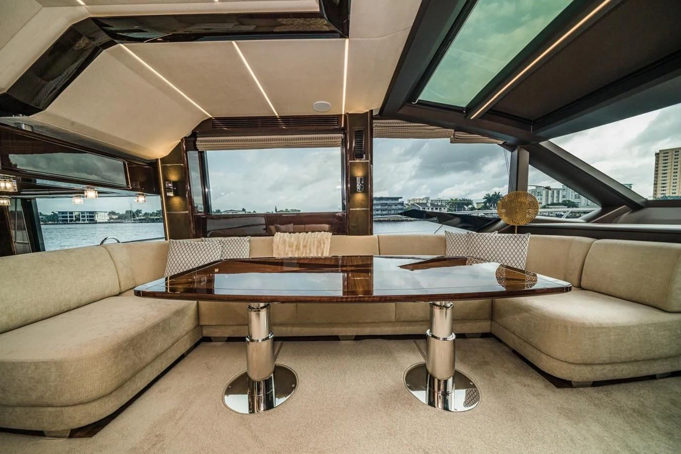 The salon features a spacious seating area with a polished wooden table and large windows offering panoramic views. aboard GALEON Yacht for Sale