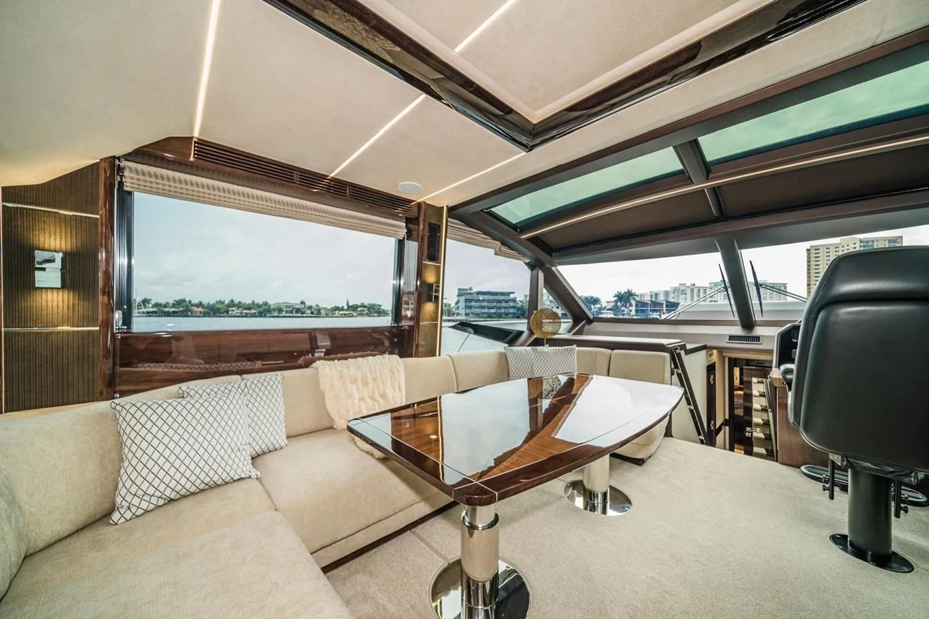 The salon features plush seating, a polished wooden table, and expansive windows offering panoramic views. aboard GALEON Yacht for Sale