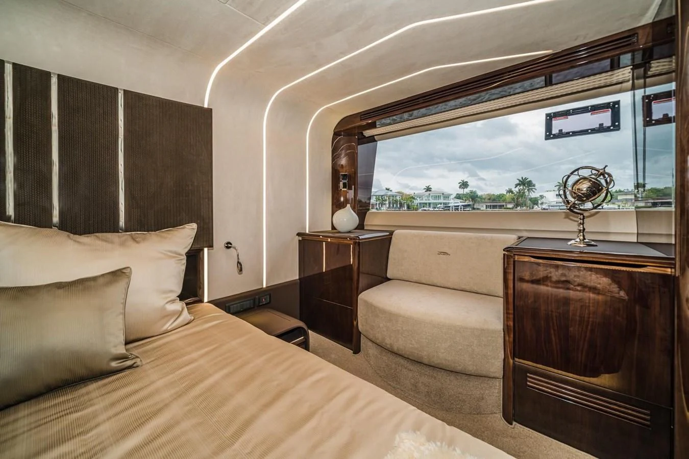 The stateroom features a luxurious bed, elegant wood finishes, and a large window offering scenic views. aboard GALEON Yacht for Sale