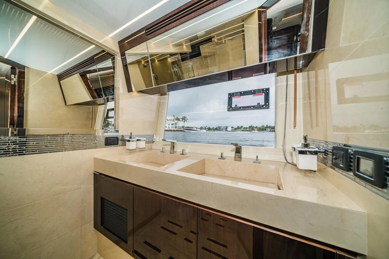 The yacht's bathroom features modern fixtures and a large window with a view of the water. aboard GALEON Yacht for Sale