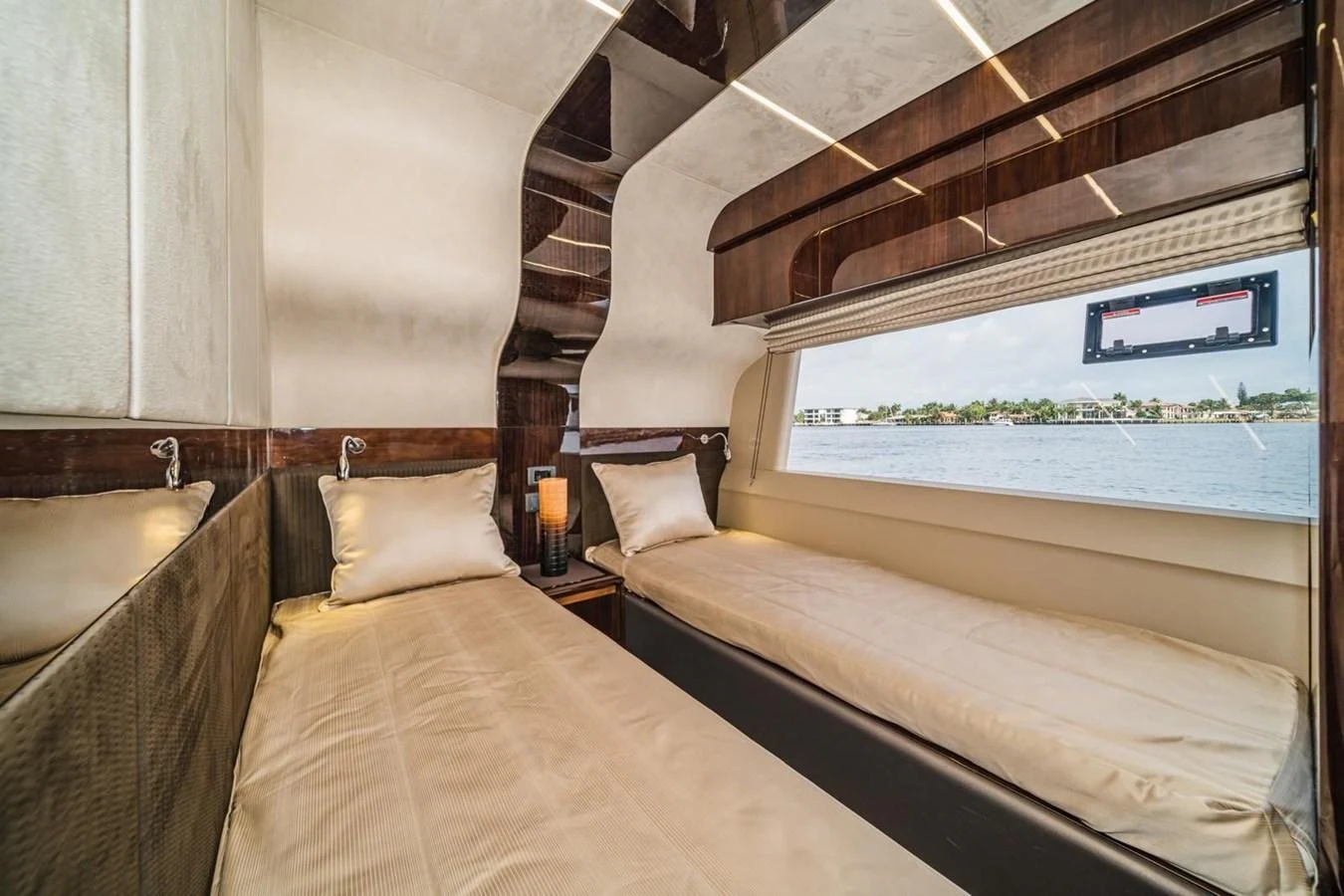 The twin stateroom offers a serene and comfortable space with a large window providing a scenic view. aboard GALEON Yacht for Sale
