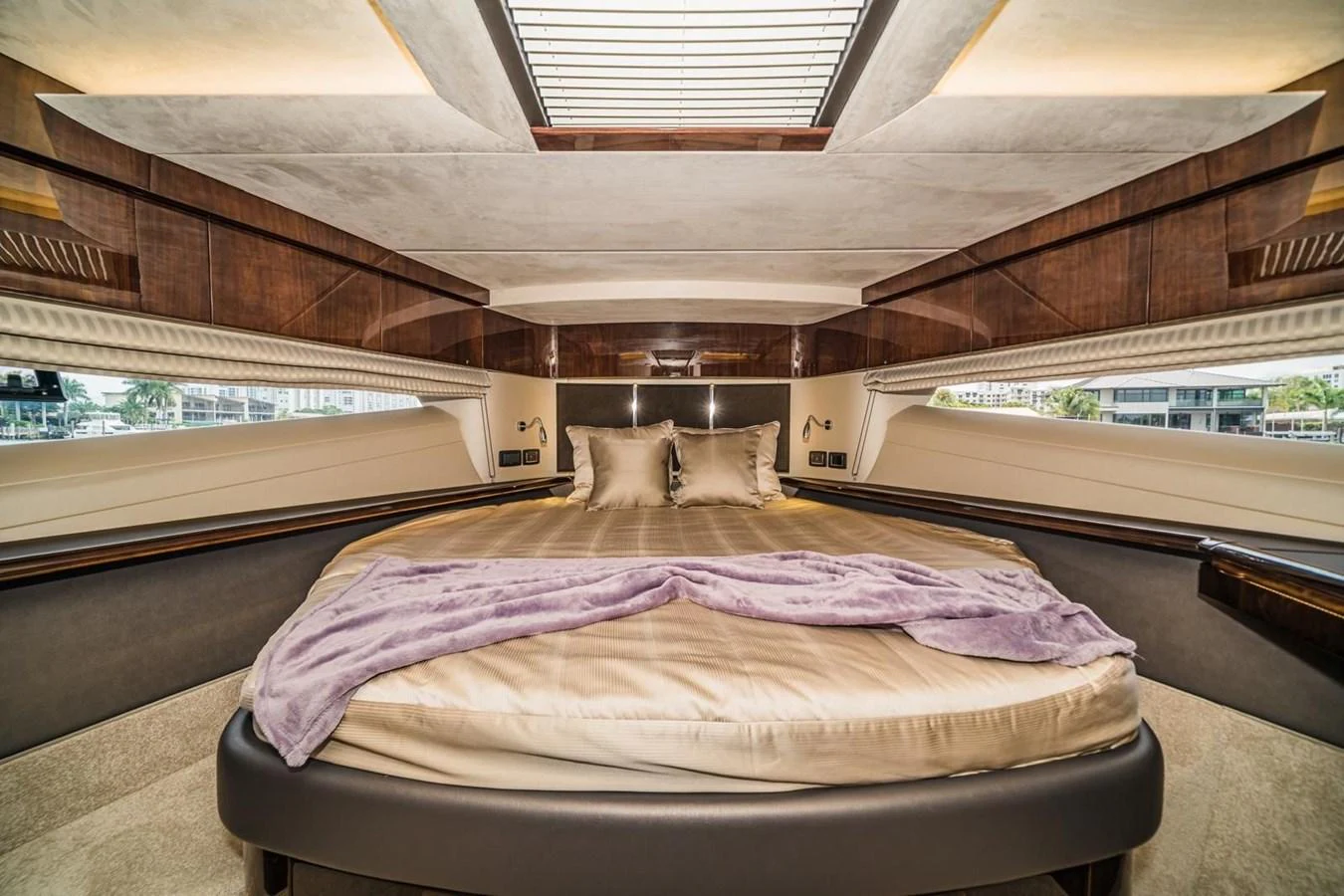 The master stateroom features a luxurious bed with elegant bedding and ample natural light from the overhead skylight. aboard GALEON Yacht for Sale