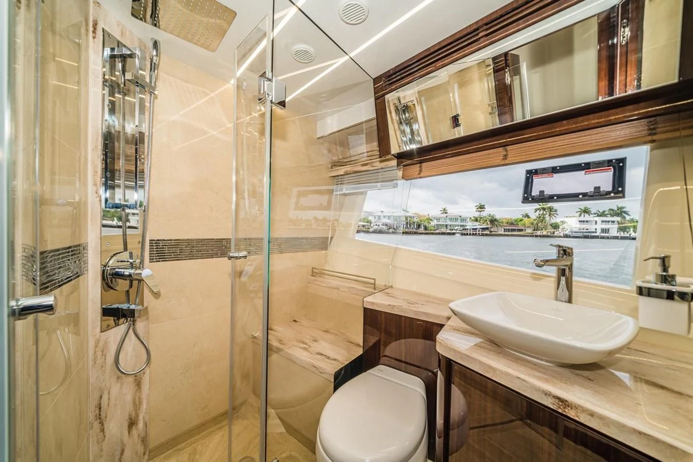 The yacht's bathroom features luxurious fixtures and a large window with a scenic view. aboard GALEON Yacht for Sale