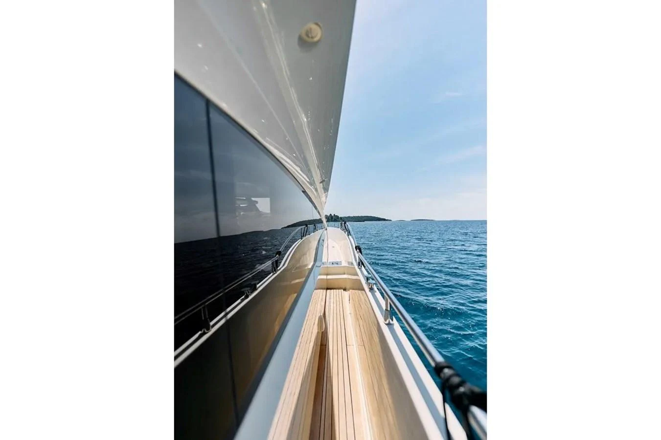 A sleek yacht glides through the open water, showcasing its polished deck and reflective windows. aboard MARQUIS 720 Yacht for Sale