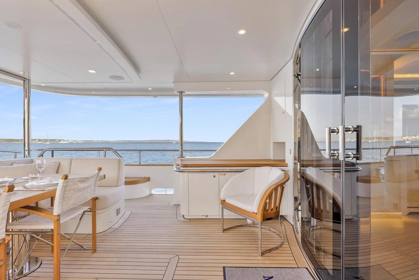 The aft deck offers a serene space with comfortable seating and a dining area overlooking the water. aboard VANADIS Yacht for Sale