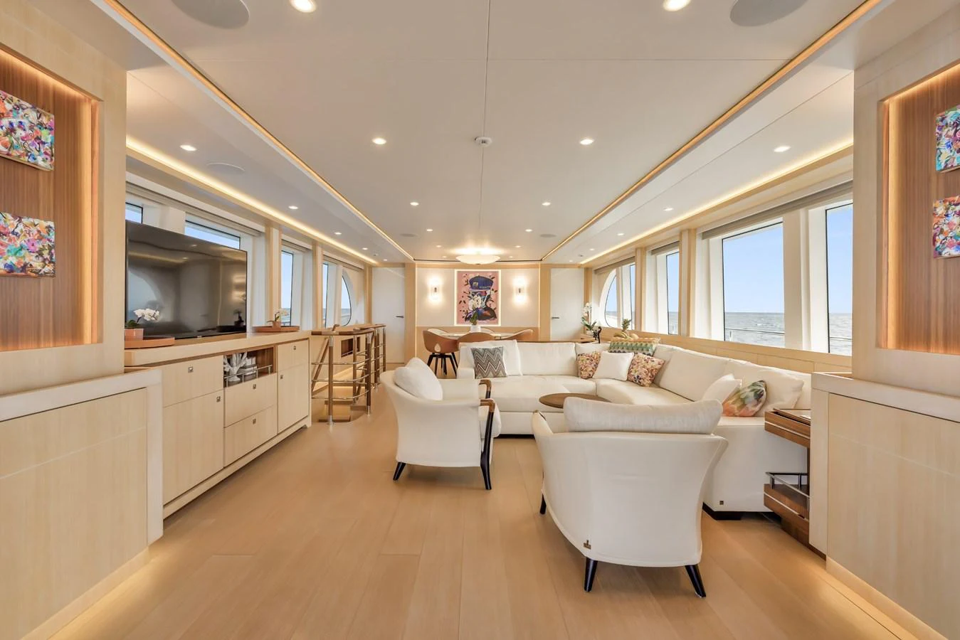 The yacht's salon features elegant seating and ample natural light through large windows. aboard VANADIS Yacht for Sale