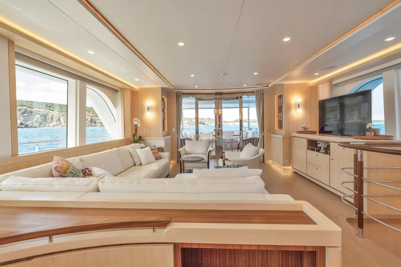 The yacht's salon features a spacious and elegant seating area with large windows offering stunning ocean views. aboard VANADIS Yacht for Sale