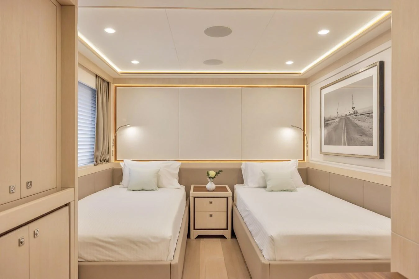 The guest stateroom features twin beds with elegant lighting and modern decor. aboard VANADIS Yacht for Sale