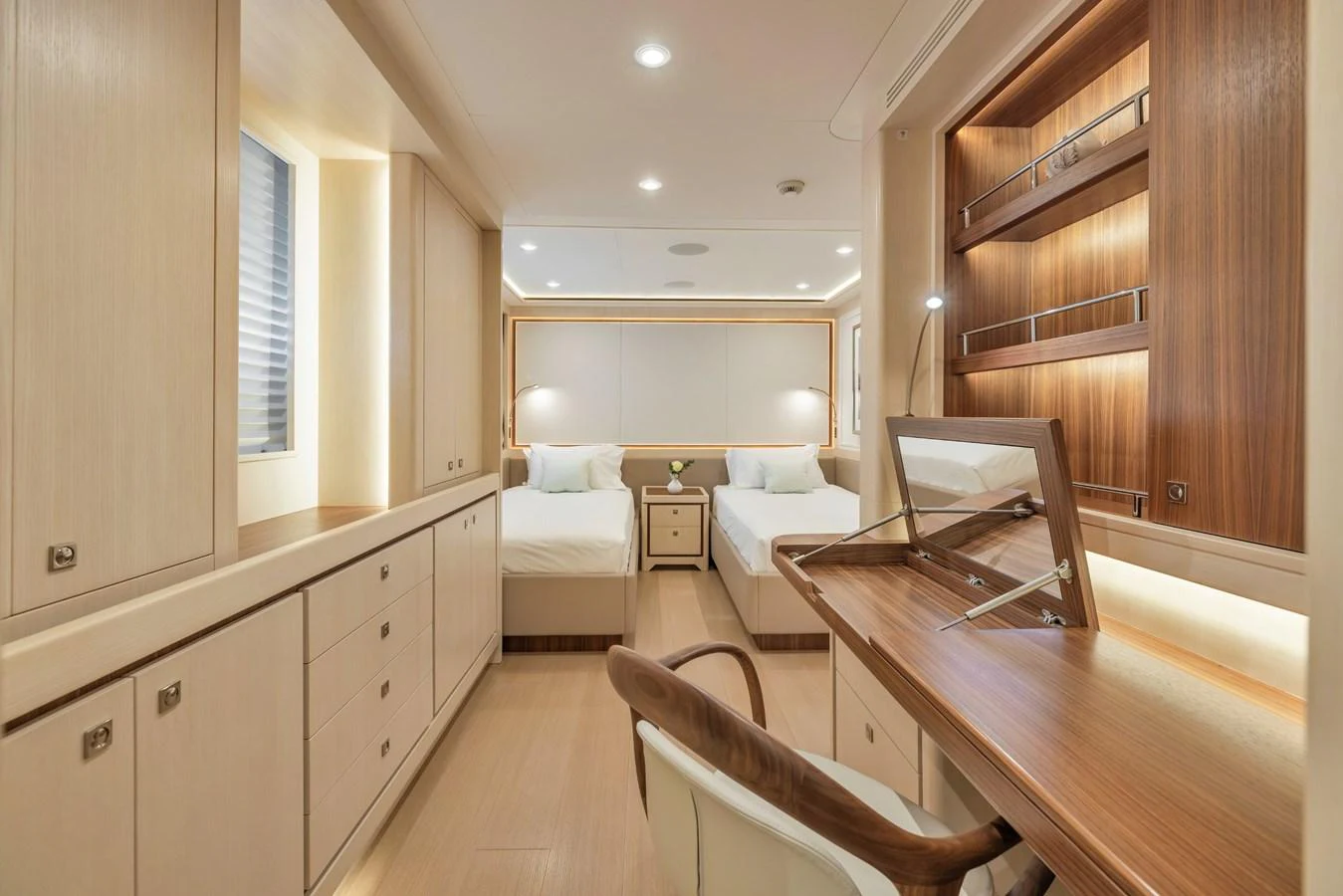 The twin stateroom offers a serene and sophisticated retreat with ample storage and a functional desk area. aboard VANADIS Yacht for Sale