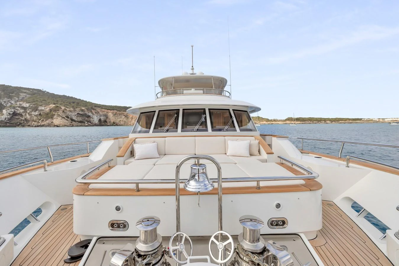 The foredeck features a spacious sunbathing area with plush cushions and a scenic view. aboard VANADIS Yacht for Sale