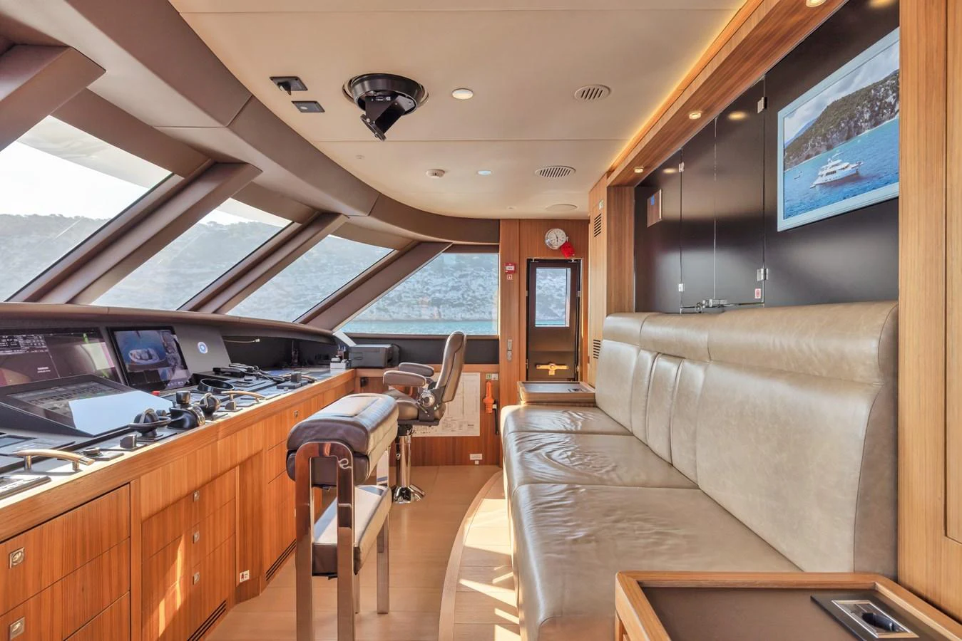 The helm station features state-of-the-art navigation equipment and a comfortable seating area with panoramic views. aboard VANADIS Yacht for Sale