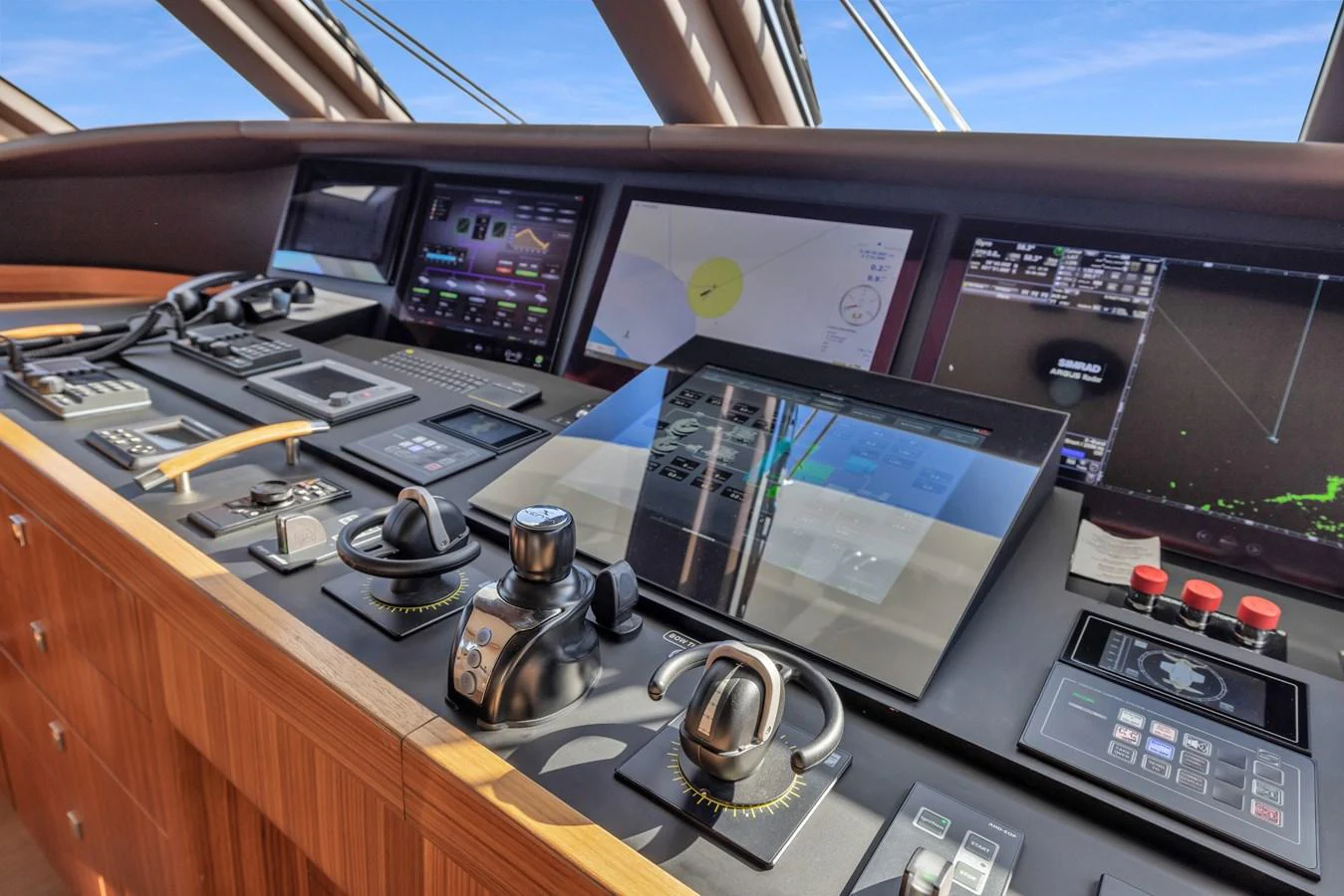 The helm station features advanced navigation and control systems with a sleek, modern design. aboard VANADIS Yacht for Sale
