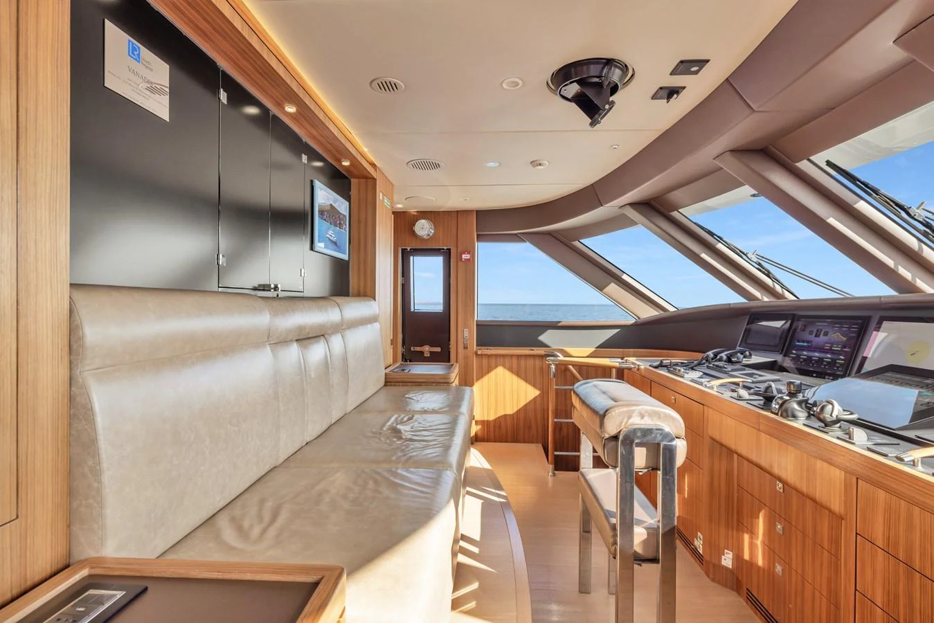 The helm station features a sleek design with advanced navigation equipment and a comfortable seating area. aboard VANADIS Yacht for Sale