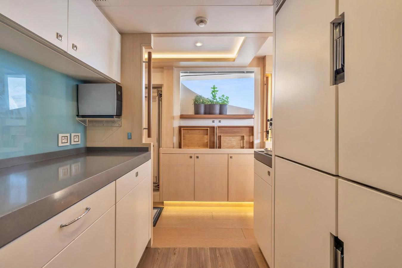 The galley features modern appliances and ample storage, illuminated by natural light. aboard VANADIS Yacht for Sale