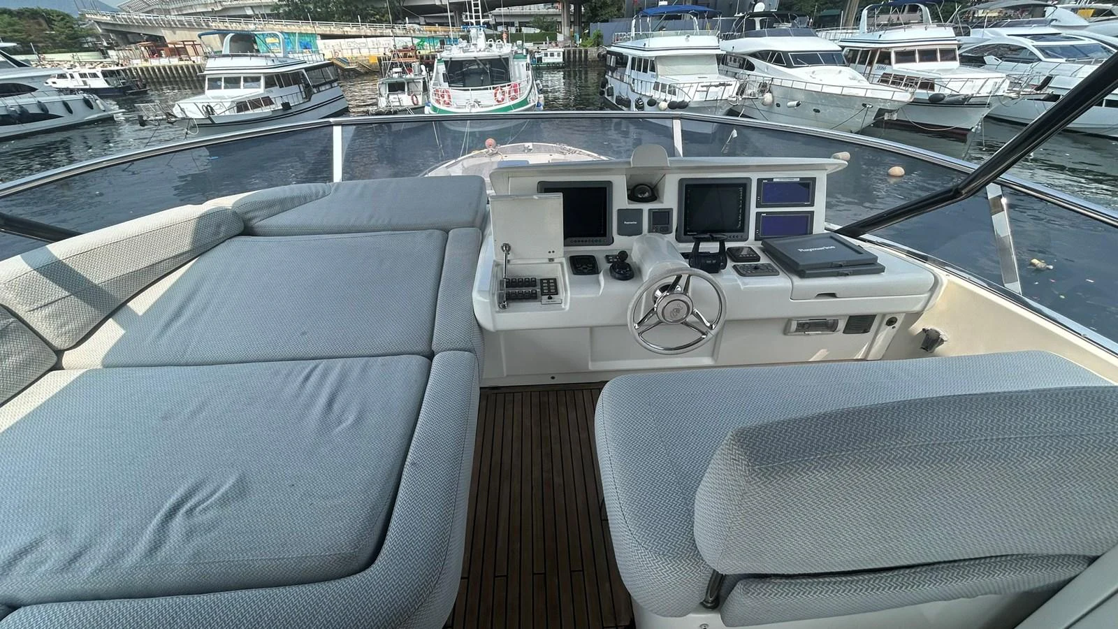 The helm station offers a comfortable and well-equipped area for navigation with plush seating and modern controls. aboard AURORA Yacht for Sale