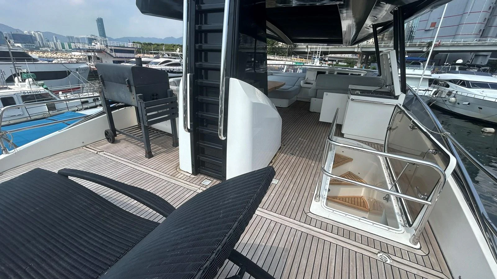The flybridge offers a spacious and inviting area with comfortable seating and a panoramic view of the marina. aboard AURORA Yacht for Sale