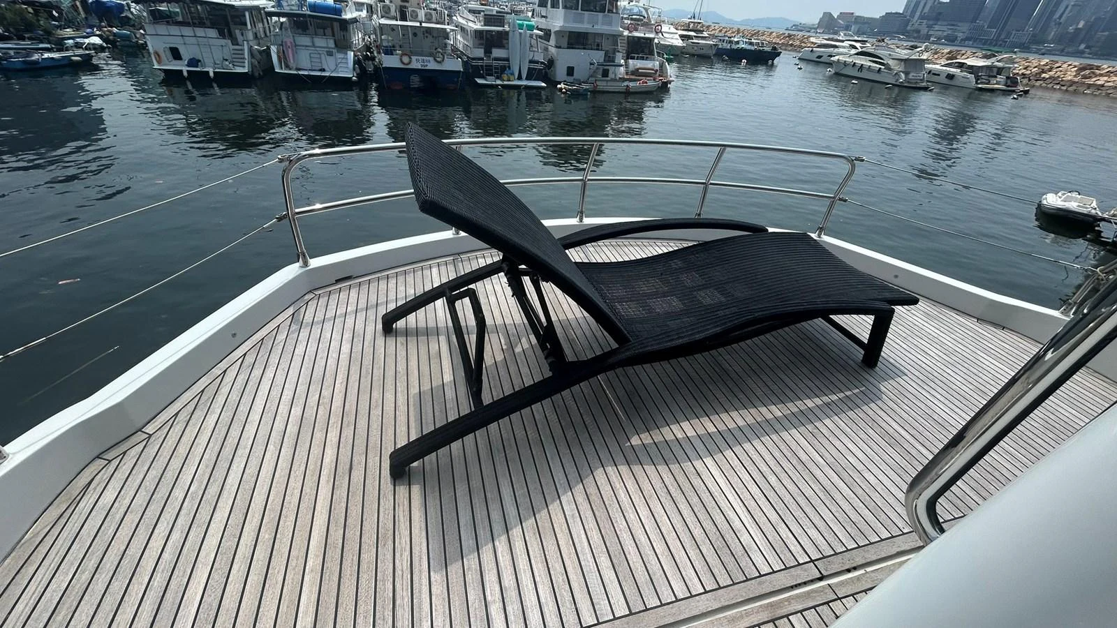 A serene sundeck with a sleek black lounger offers a perfect spot for relaxation. aboard AURORA Yacht for Sale