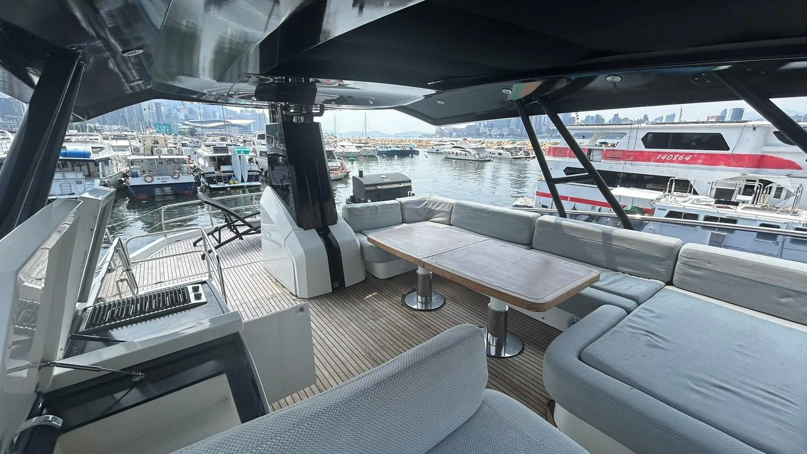 The aft deck offers a spacious and comfortable seating area with a dining table, perfect for enjoying meals with a view of the marina. aboard AURORA Yacht for Sale