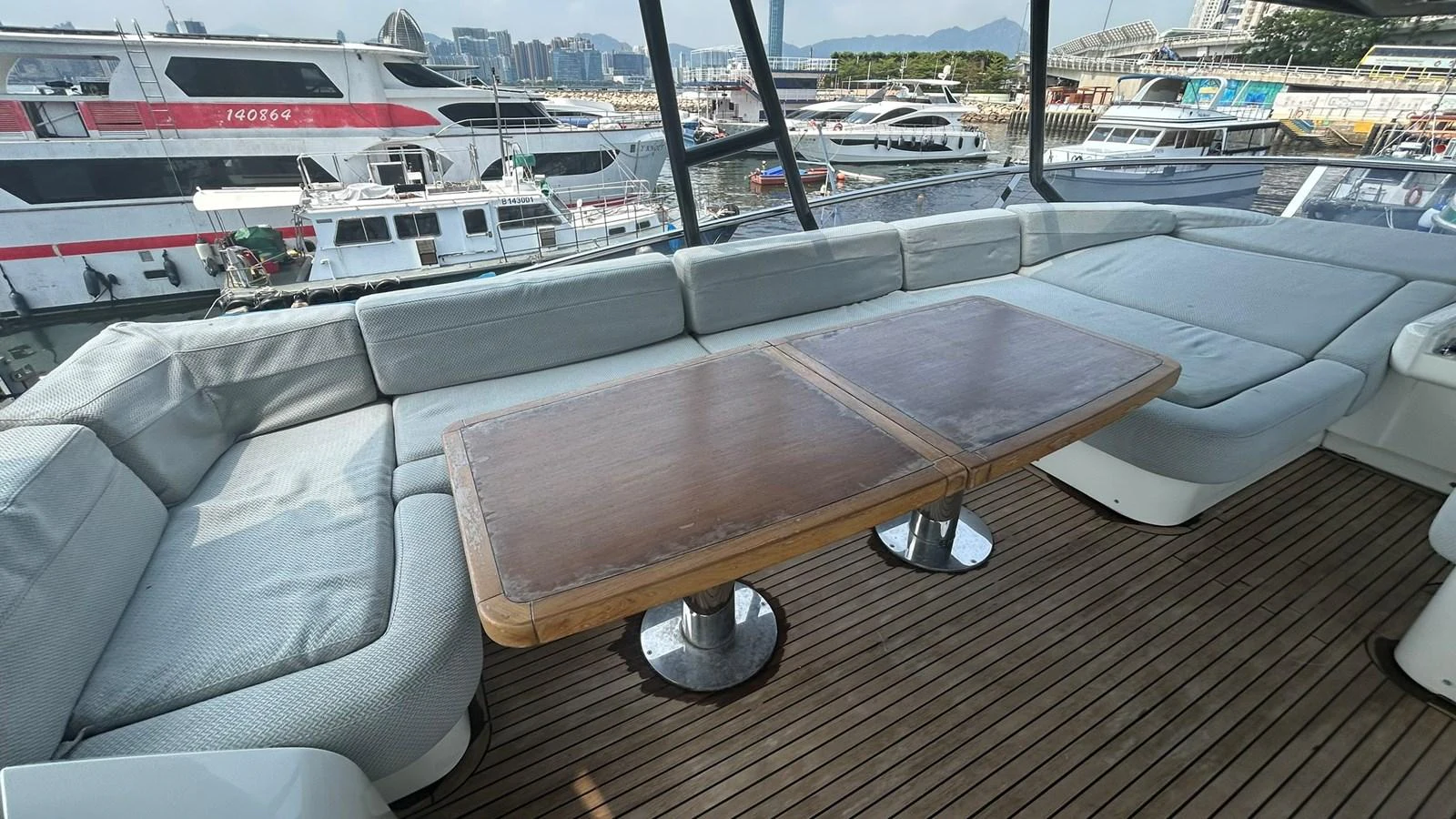 The yacht's saloon features a spacious seating area with a wooden table, perfect for relaxation and socializing. aboard AURORA Yacht for Sale