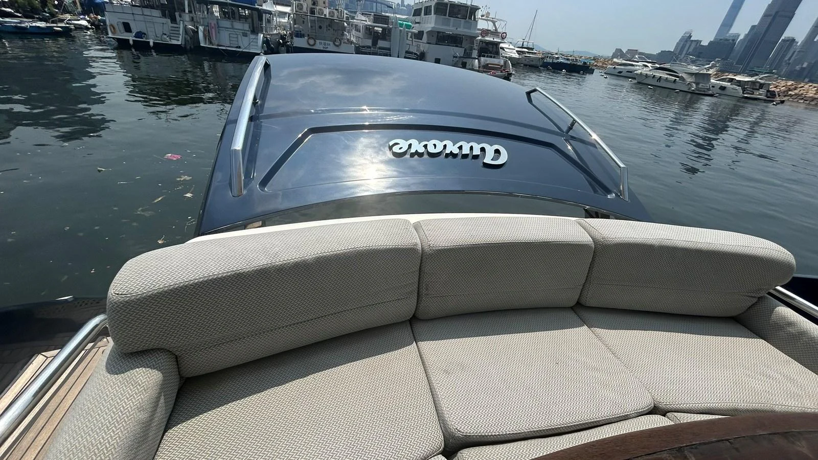 The yacht is docked in a marina, showcasing its sleek design and comfortable seating area. aboard AURORA Yacht for Sale