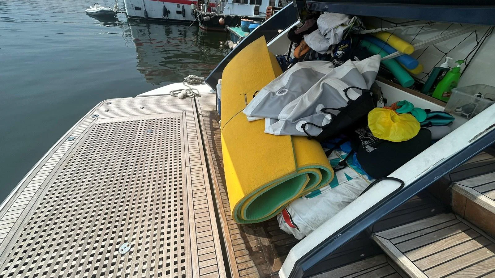 The image captures a cluttered area on the yacht with various items and equipment stored haphazardly. aboard AURORA Yacht for Sale