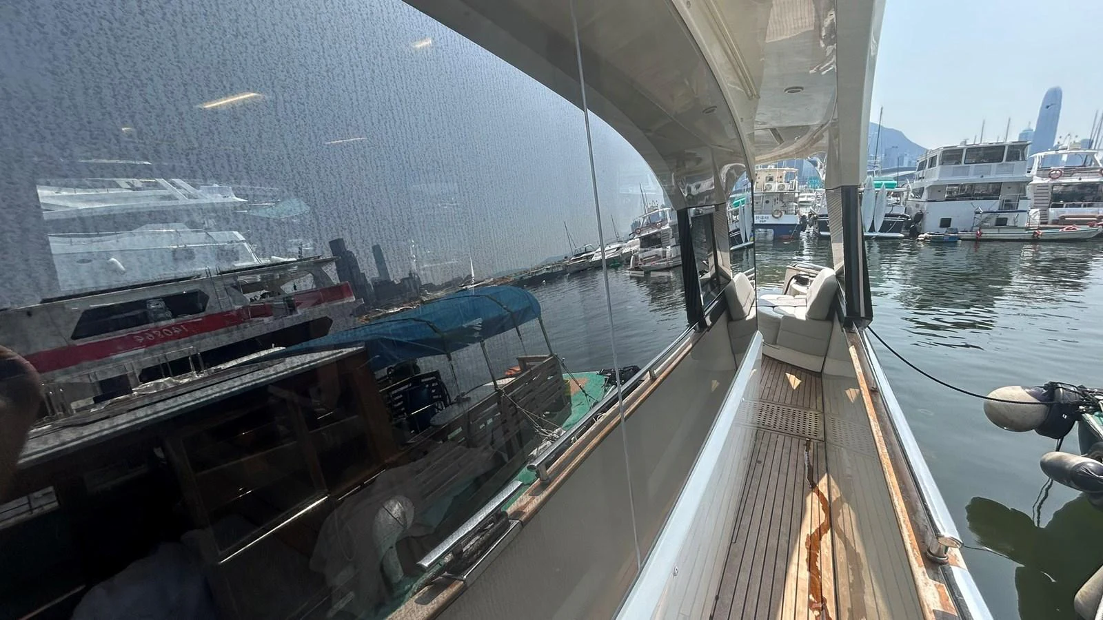 The side deck of the yacht offers a sleek walkway with a view of the marina. aboard AURORA Yacht for Sale