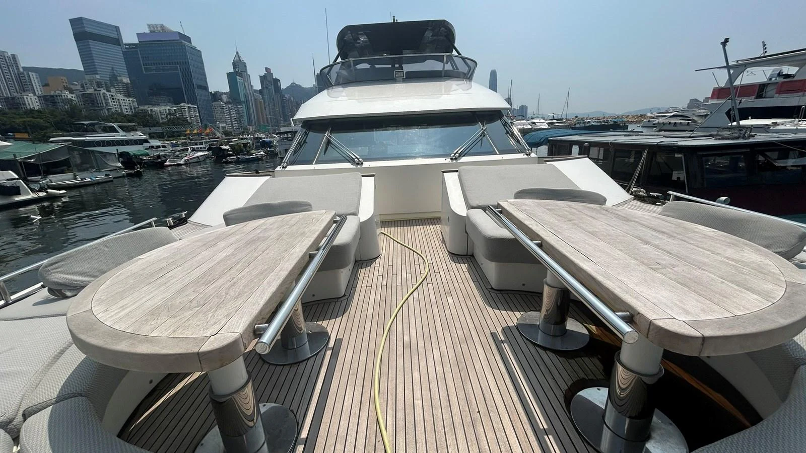 The foredeck features spacious seating and dining areas with a view of the marina. aboard AURORA Yacht for Sale