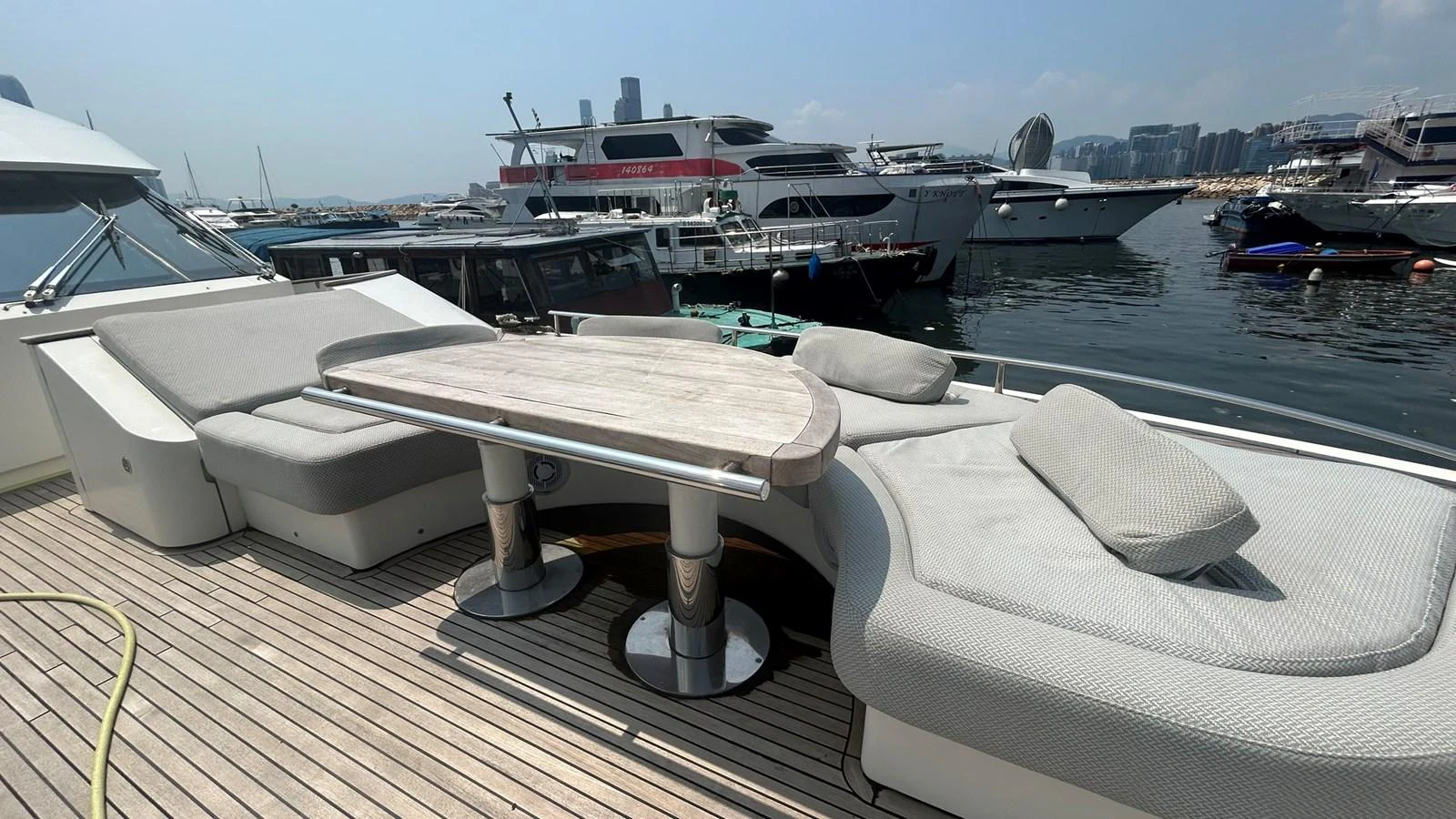 The aft deck features comfortable seating and a stylish table, perfect for outdoor relaxation and dining. aboard AURORA Yacht for Sale