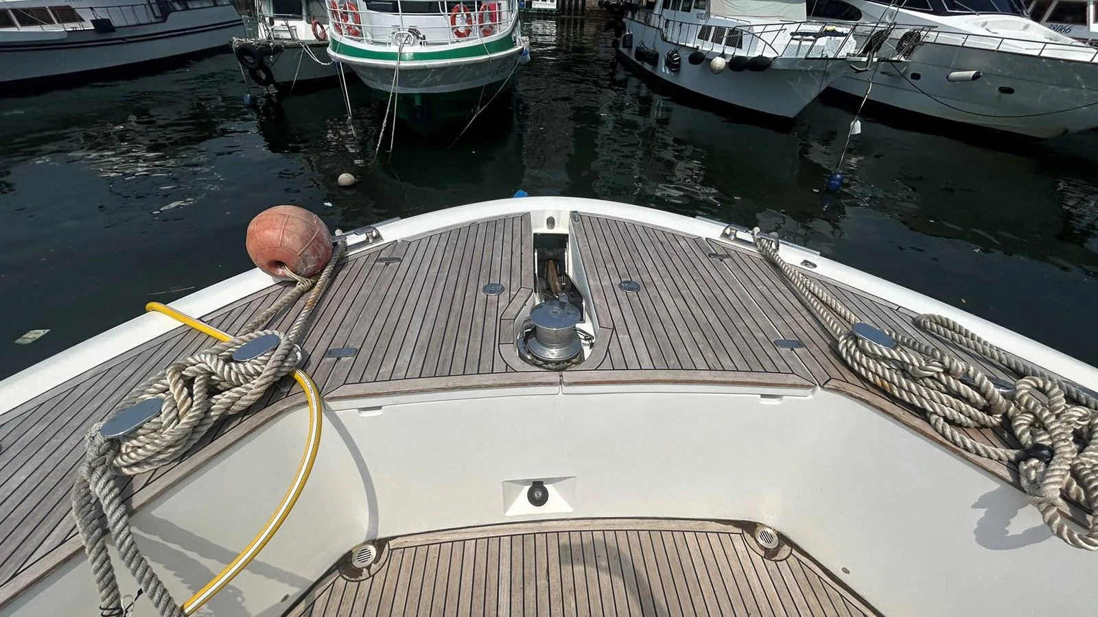 The image showcases the bow area of a yacht, featuring neatly coiled ropes and a clean deck. aboard AURORA Yacht for Sale