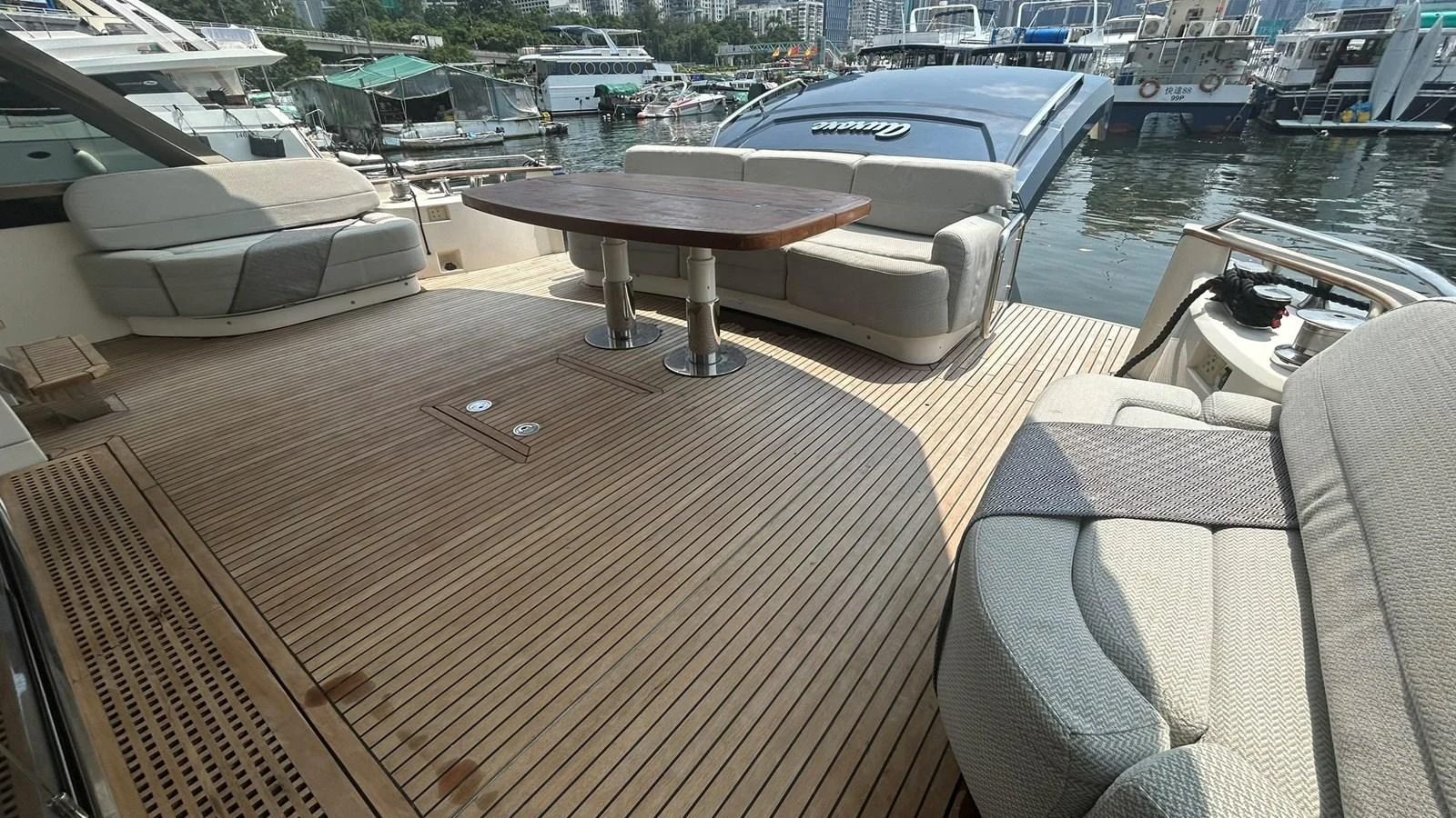The aft deck offers a spacious and inviting area with comfortable seating and a central table, perfect for outdoor relaxation and dining. aboard AURORA Yacht for Sale