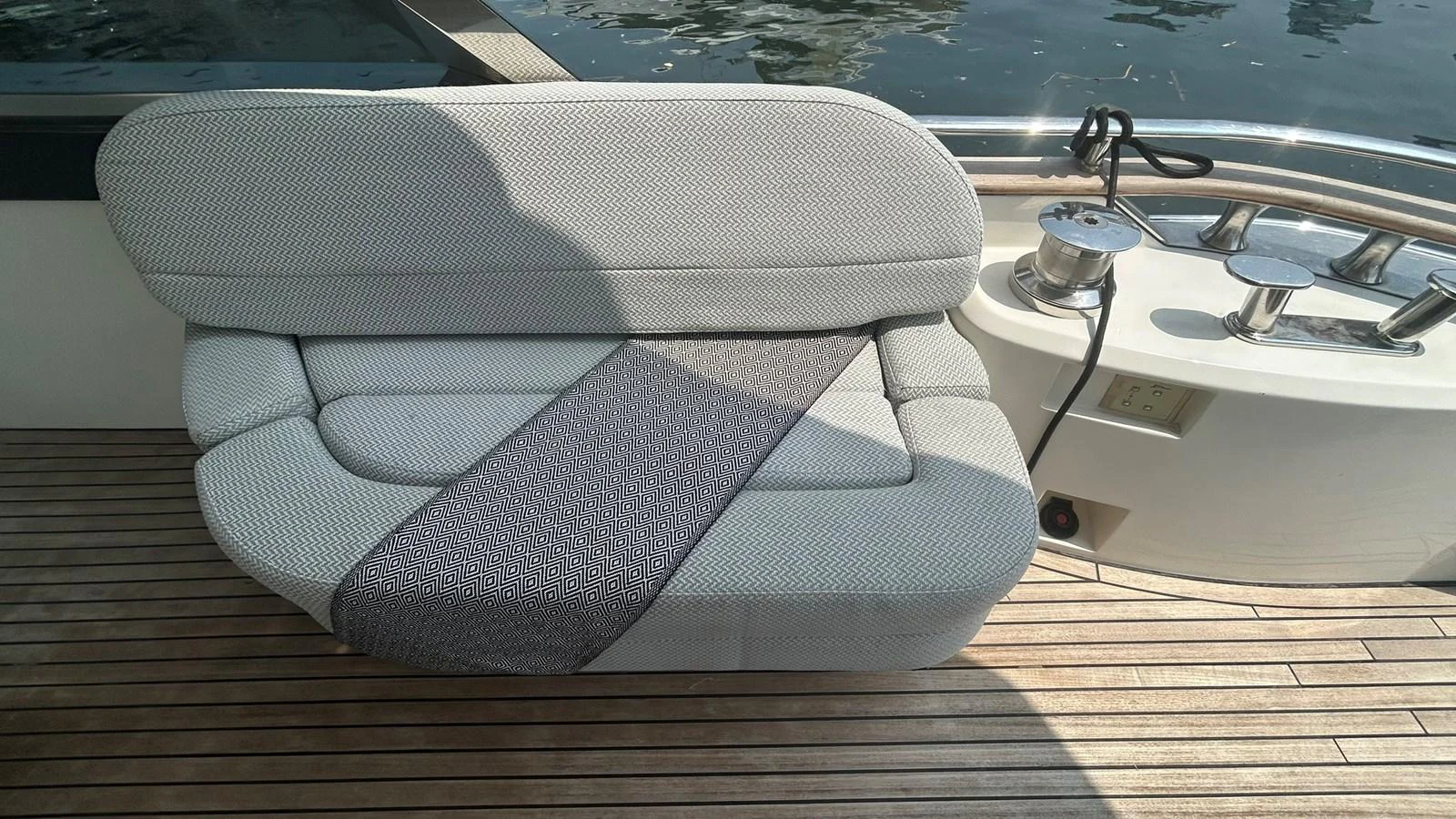 A close-up of a cushioned seating area on the yacht's deck, showcasing its comfort and style. aboard AURORA Yacht for Sale