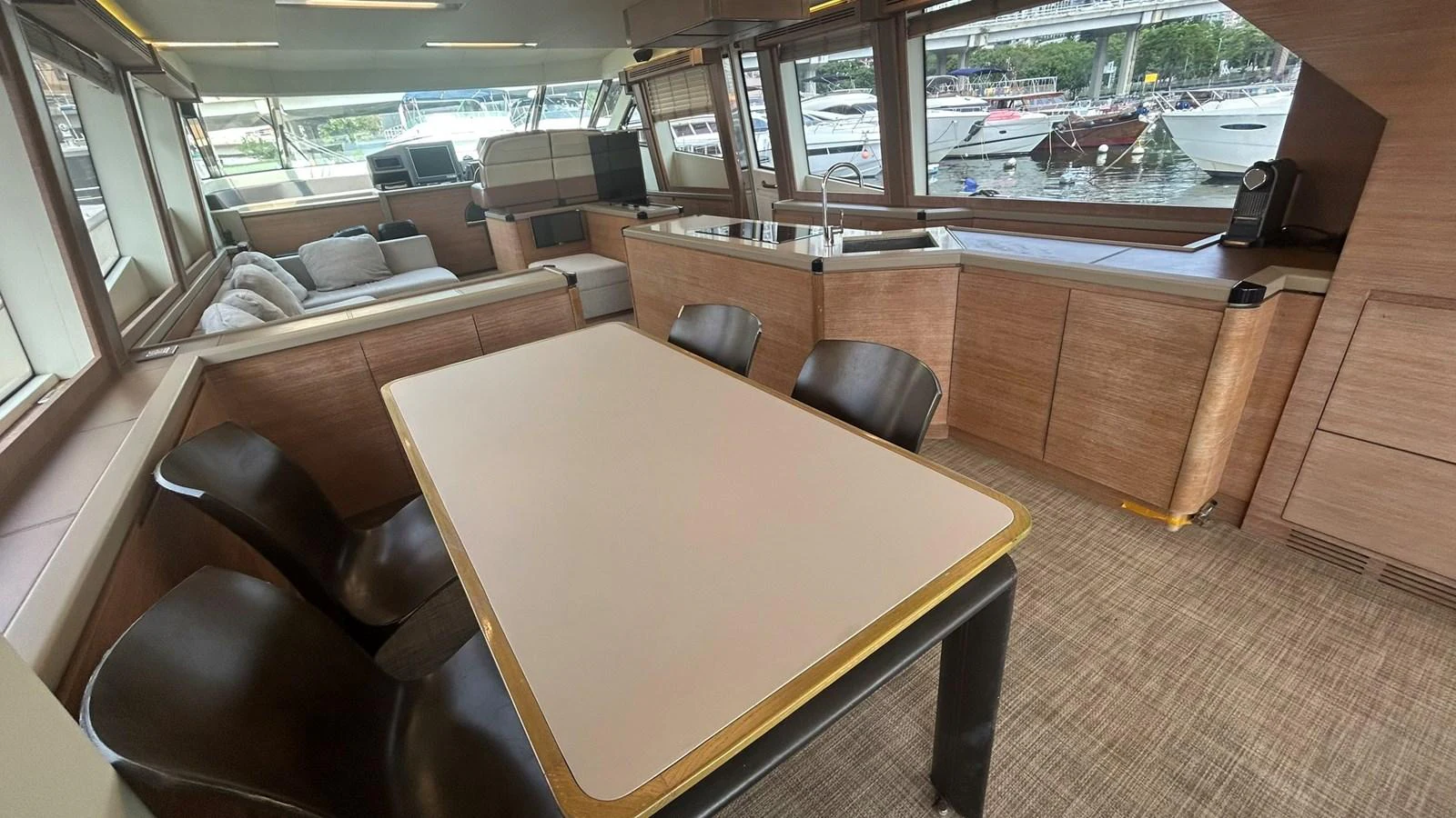The salon features a spacious dining area with modern furnishings and ample natural light. aboard AURORA Yacht for Sale