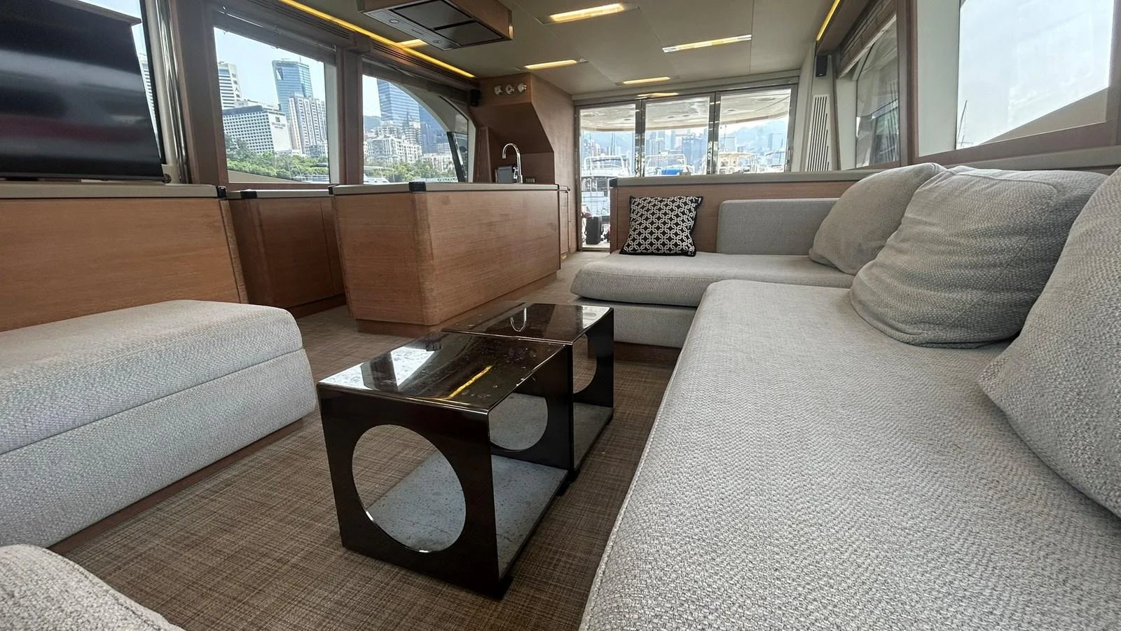 The salon features a spacious and modern seating area with a stylish coffee table and large windows offering panoramic views. aboard AURORA Yacht for Sale