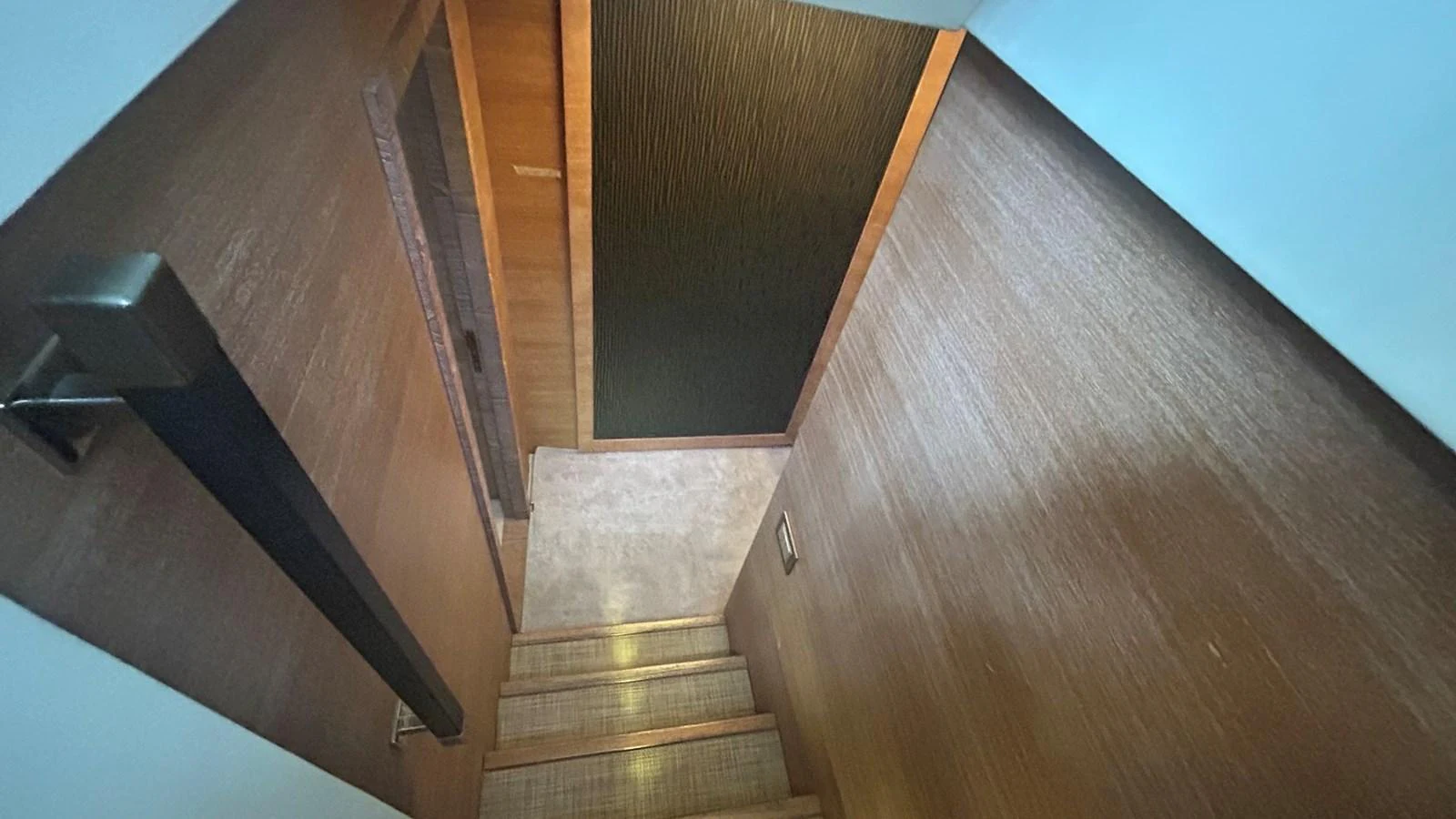 A sleek and modern staircase leads to the lower deck, featuring elegant wood paneling and ambient lighting. aboard AURORA Yacht for Sale